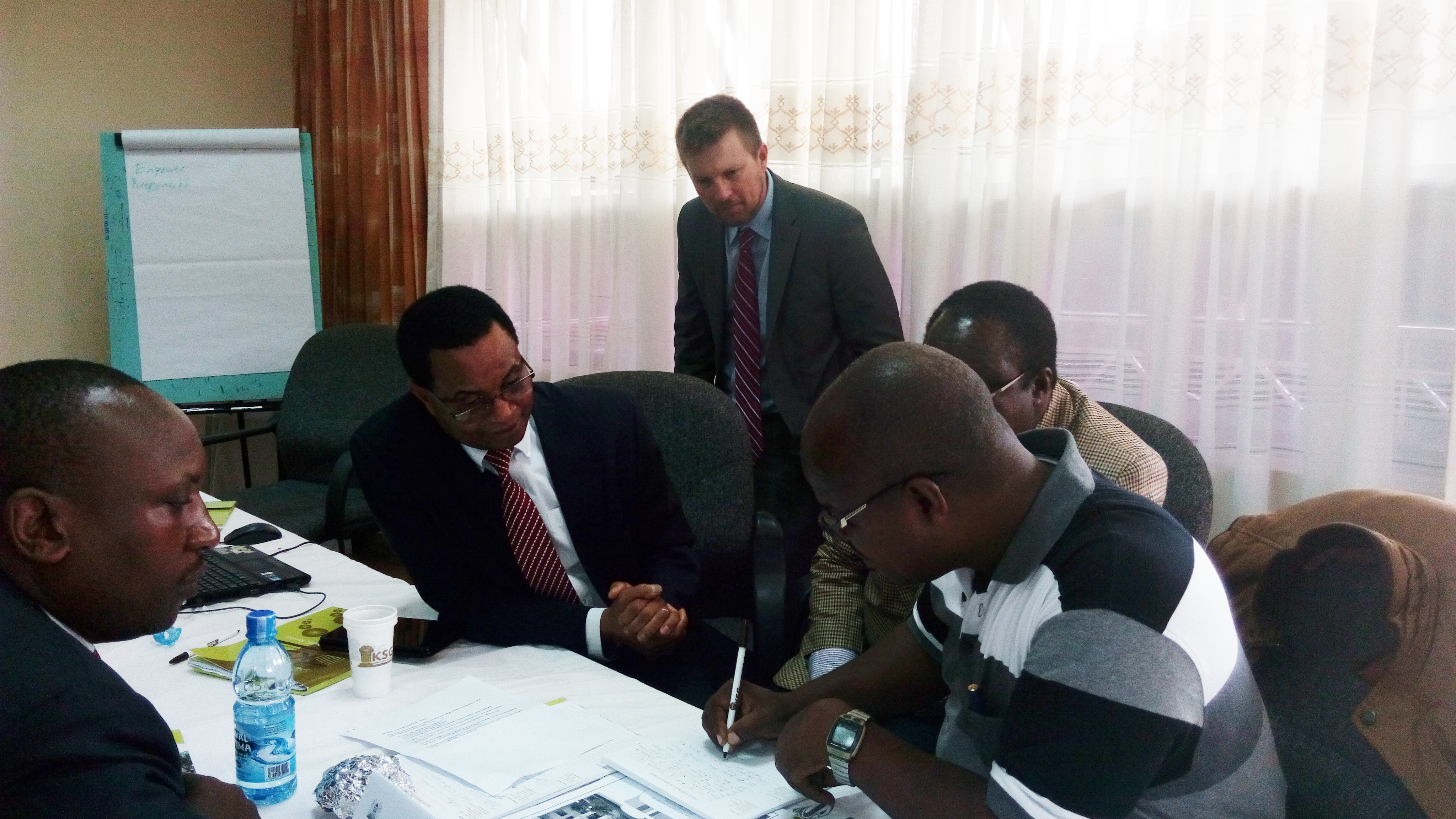 Patrick Shepherd, OGE Senior Instructor, works with senior faculty at Kenya School of Government 